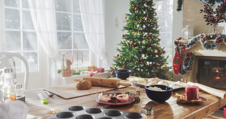 Peaceful Snowy Christmas Morning: Table with Baking Ingredients and Utensils in a Decorated Corner...