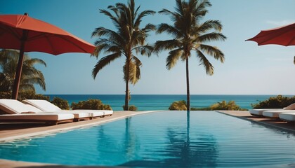 Fototapeta na wymiar Beach and sea view with luxurious swimming pool, loungers umbrellas, palm trees and blue sky