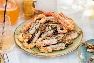 plate with Cooked seafood on a barbecue grill. Grilled shrimp.