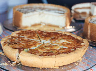 Homemade pie with fillings at the street food fair. Soft focus blurred and noise effect. Delicatessen Homemade food concept