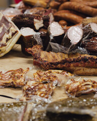 Hand made smoked meat products. Display meats, cold cuts and sausages at the street food fair. Soft focus blurred and noise effect. Delicatessen Concept