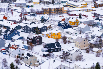 Norwegian town of Troms in the winter. Snowy arctic city with colorful houses and port