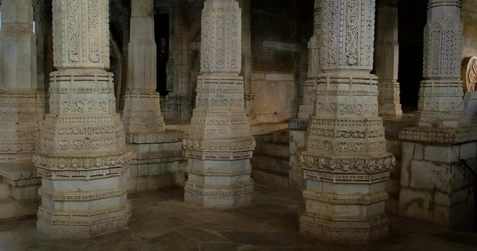 Columns of beautiful Ranakpur Jain temple or Chaturmukha Dharana Vihara. Marble ancient medieval carved sculpture carvings of sacred religious place of jainism worship. Ranakpur, Rajasthan. India