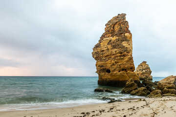 Rocky cliffs on sandy Marinha Beach in Algarve coast at Atlantic Ocean in Portugal