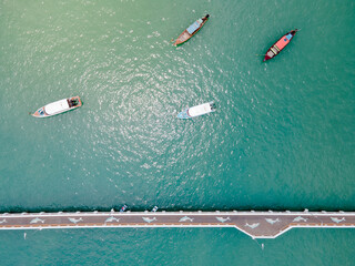 Aerial drone view of a dolphin floor pattern bridge with tourboats and speed boats anchored around...