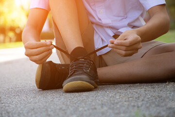 Closeup image of tying shoelace getting ready for exercise afterschool of asian schoolboy, concept...