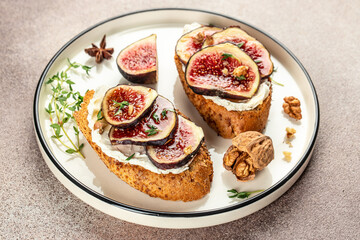 Gourmet snack, Toast bruschetta with ricotta, figs on plate on a light background top view. place for text