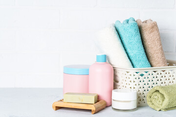 Fototapeta na wymiar Cosmetic products and clean towels in the bathroom.