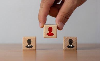 hand choose wood cube block with red businessman icon for human resources management and recruitment business, build team, leadership, outstanding smart person concept