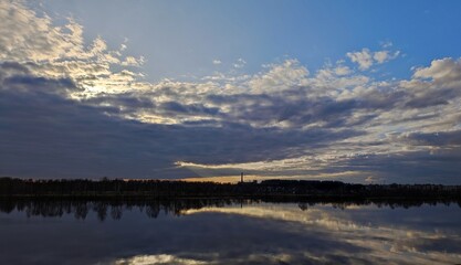 Sunset on the river in the clouds