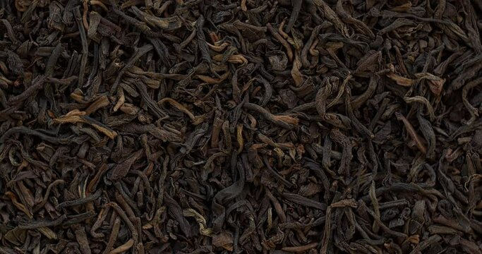 Top view of unpressed pu-erh tea background texture. Table spin.