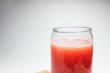 Tomato juice in a glass and fresh tomatoes