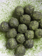 Green tea matcha truffles or bliss balls. Energy balls. Healthy raw desserts. Top view.