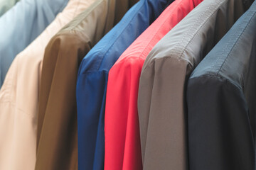 Multi-colored jackets for men on hangers in the store