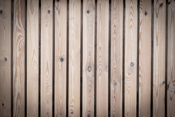 The background is made of pine planks arranged vertically. Space for text. High quality photo