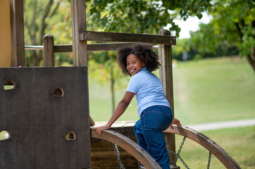 Cute african american girl playing outside and looking contented
