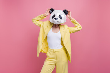 Photo of cool classy costume girl hands touch 3d panda mask mardi gras event party isolated on pink...