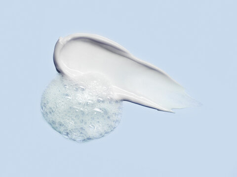 Skincare cream cosmetic anti aging stroke with cleanser foam texture bubbles isolated on pastel pink background. Soap shampoo face wash cleansing musse product sample