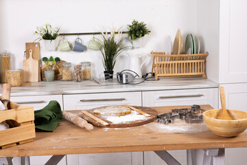 In a bright kitchen, gingerbread dough is lying on the table