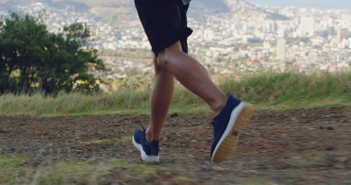 Man, legs and running on mountain in nature for cardio workout, training or outdoor exercise. Closeup of male person, athlete or runner on hill, path or trail for sport, fitness or feet and shoes