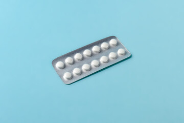 pills and tablets in a blister pack on blue background. healthcare and medicine concept.