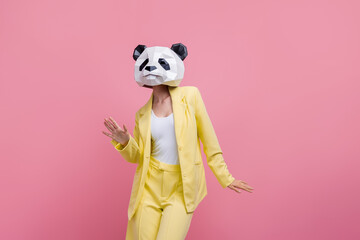 Photo of carefree excited 3d panda mask girl enjoy dancing clubbing wear elegant clothes isolated on pink color background