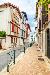 Fototapeta na wymiar Colorful Basque buildings in the old town of Saint-Jean-de-Luz, France