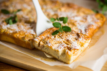 prepared curd semolina pie with quince inside and covered with powdered sugar .