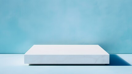 Square Stone Podium in front of a cyan Studio Background. White Pedestal for Product Presentation