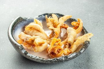 fried seafood beer platter with fish and shrimps on a light background top view. place for text