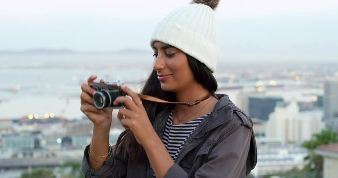 Camera, photography and woman taking a picture in the city on an outdoor adventure or vacation. Travel, urban town and young female person taking a photo on a weekend trip for tourism journey.