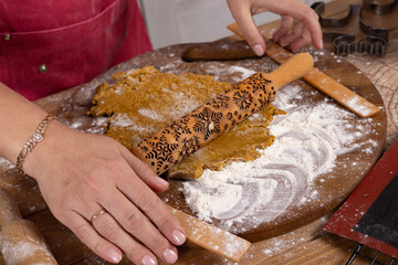 Roll out the dough on the table with a carved rolling pin