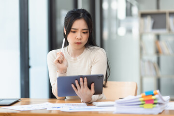 Asian businesswoman are stressed and tired from work sitting at desk in the office, feeling sick at work, stress from work.	