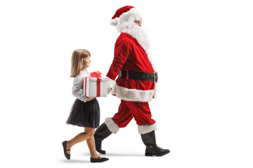 Santa claus holding a girl with a present by the hand and walking
