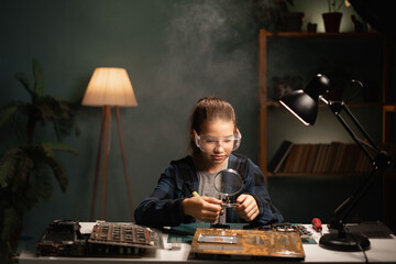 Female student uses soldering iron. She is repairing computer. Hardware engineering, technology and...