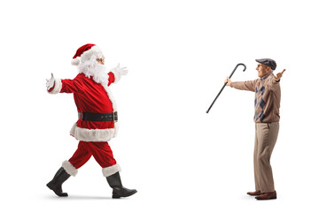 Full length profile shot of excited santa claus meeting a friend