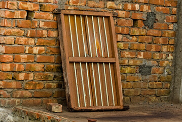 Fototapeta na wymiar an old wooden frame window kept beside a wall