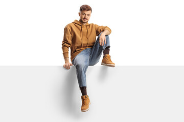 Generation z guy sitting on a blank panel