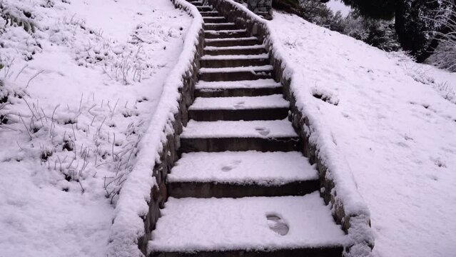 View of the garden staircase in winter. Foot tracks in the steps.