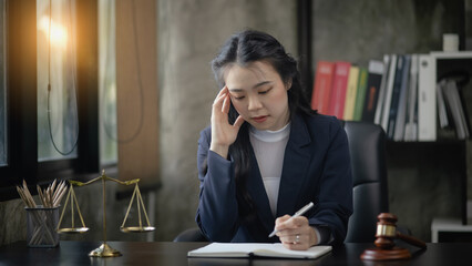 Lawyer woman stressed and tired from work in a courtroom, legal services, justice and law concept.