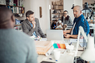 Fototapeta premium Group of people working together on a project in a startup company office