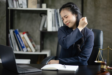 Lawyer woman stressed and tired from work in a courtroom, legal services, justice and law concept.