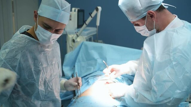 A team of surgeons performed a successful operation, stitches and stitches up the wound.