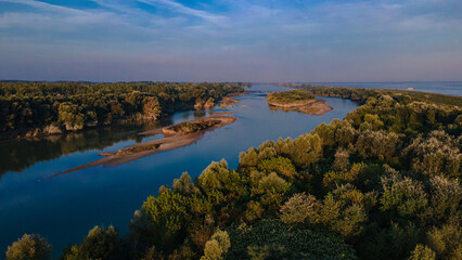 Aerial view over Danube river near Bratislava, Slovakia. The Photography was shoot from a drone at a higher altitude above the river in the morning at sunrise.