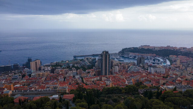 Aerial view over the city of Monaco, Monte Carlo. Photography was shoot from a drone at a higher altitude from above the city with the marina and sky scrapeprs on a stormy weather.