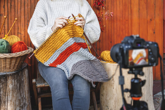 Woman vlogging her knitting technique and skill. Creative female vlogger live streaming on social media