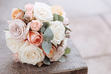 Bouquet of roses on stone surface with blurred background. Concept for wedding, anniversary,...