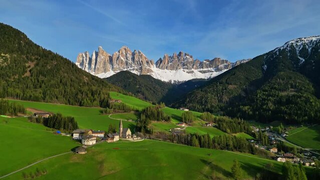 Spring landscape with shurch in Santa Magdalena village, Italian Dolomites Alps, in South Tyrol, Val di Funes, Italy, 4k