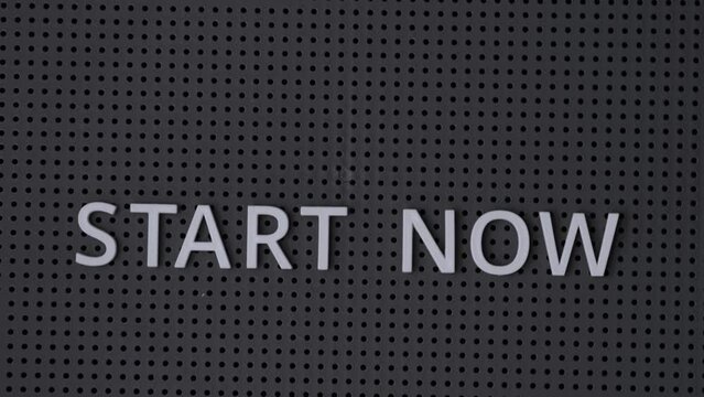 Words Start Now spelled out with white letters on a gray pegboard