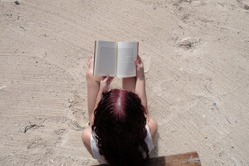 woman reading on the beach